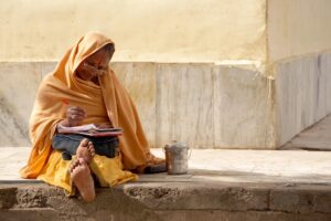 Morning Prayer For Widows: Elderly widow writing prayers in her journal.
