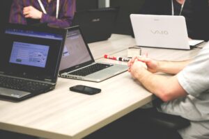 Morning Prayers For Entrepreneurs: Entrepreneur praying quietly at desk before opening laptop